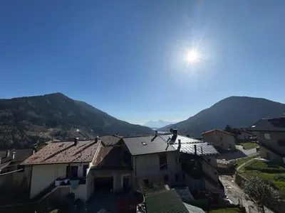 a view of a house with the sun in the sky at La Casa del Zio Bepi in Bedollo