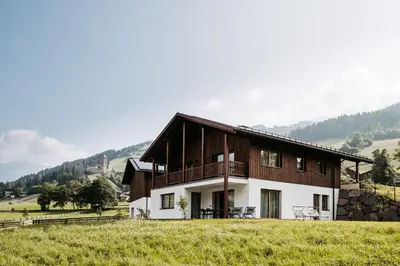 a house in the middle of a field at Baumannhof in Sarntal