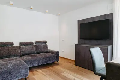 a living room with a couch and a flat screen tv at Baumannhof in Sarntal