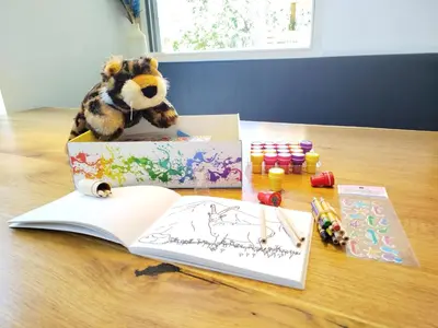 a stuffed bear is sitting in a open book on a table at Panorama-Designapartment mit Kamin, Terrasse & Bergblick Nähe Sterzing - Villa Tribulaunblick in Colle Isarco