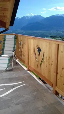 a view from the balcony of a house with a wooden door at Agritur Rizzi di Inama Ugo in Coredo