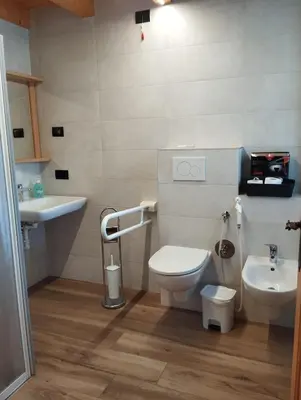 a bathroom with two sinks and two toilets at Agritur Rizzi di Inama Ugo in Coredo