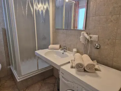 a bathroom with a sink and a shower at Apartmenthaus am Waalweg in Caines