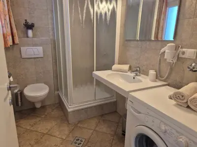 a bathroom with a sink and a toilet and a shower at Apartmenthaus am Waalweg in Caines