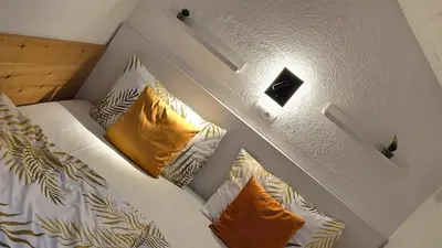 a bed with white sheets and yellow pillows at Hike, Bike & More in Parcines