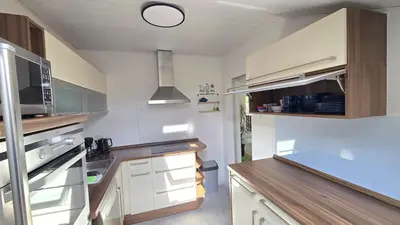 a kitchen with white cabinets and a stainless steel appliances at Hike, Bike & More in Parcines