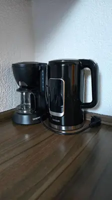 two coffee pots sitting on top of a wooden table at Hike, Bike & More in Parcines