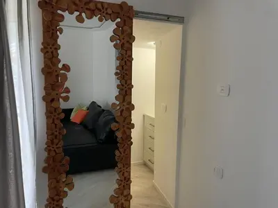 a large mirror in a living room with a couch at Casa Tilì in Ziano di Fiemme