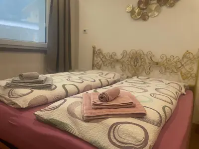 two beds with towels sitting on top of them at Casa Tilì in Ziano di Fiemme