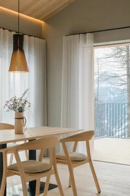 a dining room with a table and chairs and a window at Chalet Herol in Luson