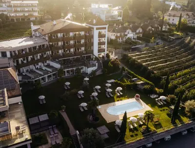 an aerial view of a resort with a swimming pool at Alpenpalais Kröll in Schenna