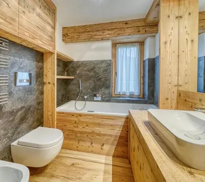 a bathroom with a tub and a toilet and a sink at Luxury apartment in Cortina in Cortina dʼAmpezzo