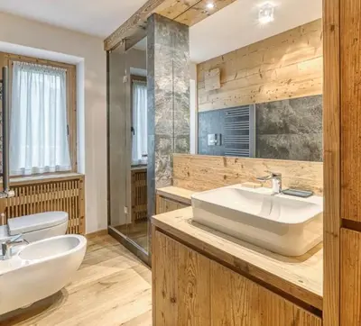 a large bathroom with a sink and a toilet at Luxury apartment in Cortina in Cortina dʼAmpezzo