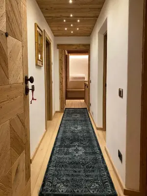 a hallway with a rug on the floor at Luxury apartment in Cortina in Cortina dʼAmpezzo