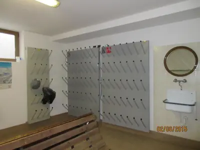 a room with a toilet and a mirror on a wall at La Majon Apartments in Selva di Val Gardena