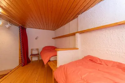 a small room with two beds and a wooden ceiling at Principe Marmolada 816 A in Malga Ciapela