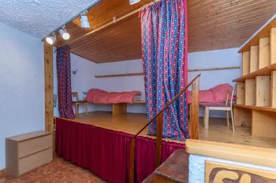 a room with a stage with red and blue curtains at Principe Marmolada 816 A in Malga Ciapela