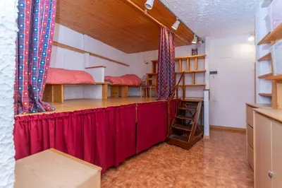 a room with two bunk beds and a red curtain at Principe Marmolada 816 A in Malga Ciapela