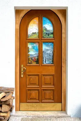 a bed in a wooden room with two windows at Le porte dell'agordino in Zenich