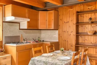 a kitchen with a table with plates on it at Le porte dell'agordino in Zenich