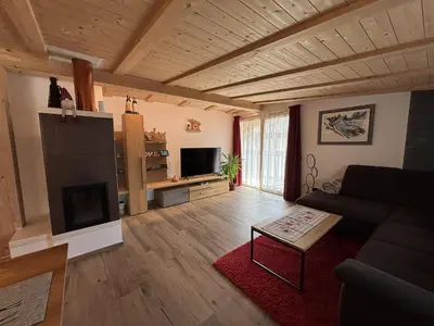 a living room with a couch and a fireplace at Appartamento Cima 12 in Pozza di Fassa