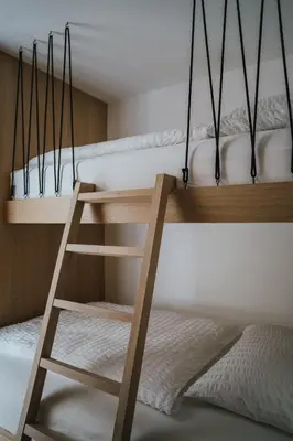 a black canopy bed in a bedroom with a window at Brondstott Farm & Suites Kronplatz in Riscone
