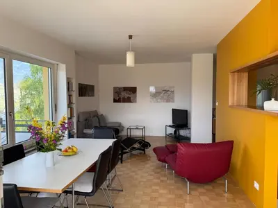 a living room with a white table and chairs at MERANEA- sonnig - ruhig - elegant - ideal zum länger bleiben - Glasfaser in Merano