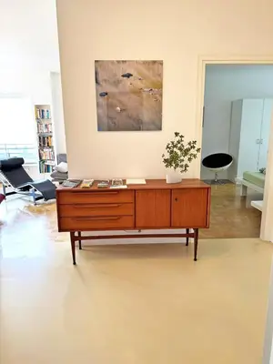 a living room with a wooden dresser in a room at MERANEA- sonnig - ruhig - elegant - ideal zum länger bleiben - Glasfaser in Merano