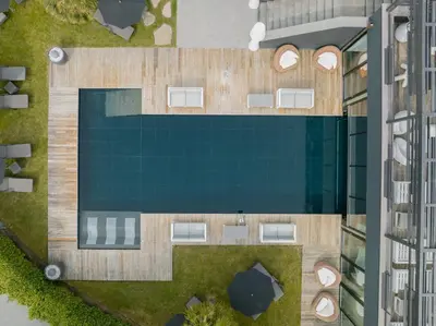 an overhead view of a swimming pool in a building at Hotel Gartner in Tirolo