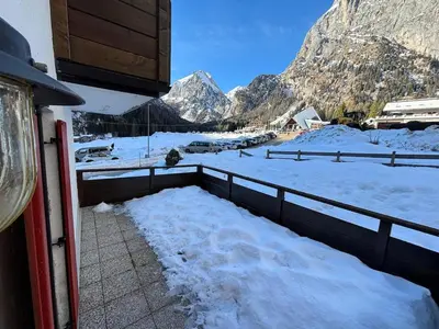 a view of a snow covered mountain with a fence at Marmolada Escape in Malga Ciapela