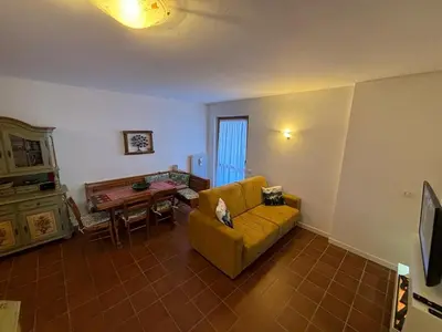 a living room with a couch and a table at Marmolada Escape in Malga Ciapela