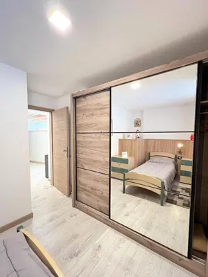 a bedroom with a bed and a large sliding glass door at tabià piz meda in Moena