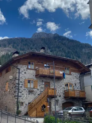 a building with wooden balconies on the side of it at tabià piz meda in Moena
