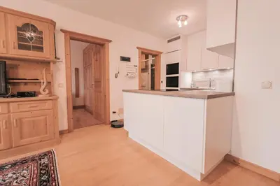 a kitchen with a white counter top and a sink at Ladin Apartment in Antermoia