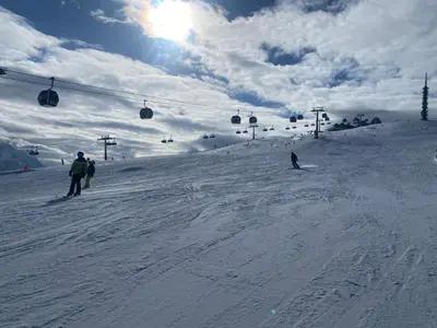 a group of people skiing down a snow covered slope at Ladin Apartment in Antermoia