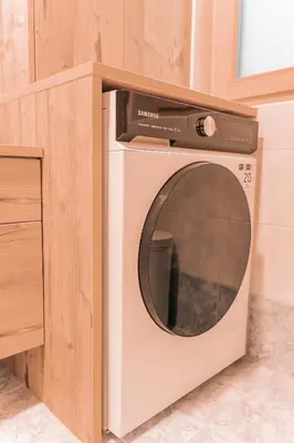 a microwave sitting on top of a washing machine at Ladin Apartment in Antermoia