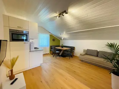 a living room with a couch and a table at Wiesenheim- Schlernblick in Penone
