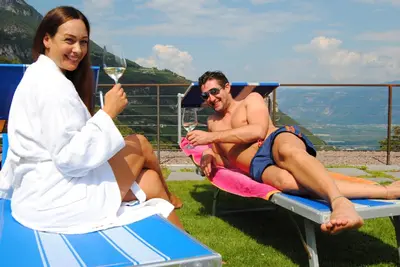 a man and a woman sitting on a beach chair at Wiesenheim- Schlernblick in Penone