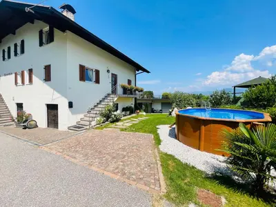 a house with a swimming pool next to a house at Wiesenheim- Schlernblick in Penone