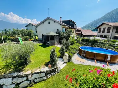 a garden with a swimming pool and a house at Wiesenheim- Schlernblick in Penone