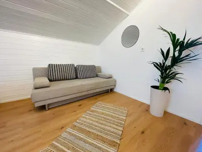a living room with a couch and a rug at Wiesenheim- Schlernblick in Penone