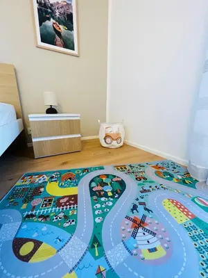 a bedroom with a colorful rug on the floor at Wiesenheim-Dolomitenblick in Penone