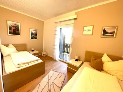 a bedroom with two beds and a window at Wiesenheim-Dolomitenblick in Penone