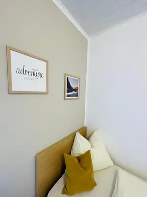 a bedroom with a bed with two pillows at Wiesenheim-Dolomitenblick in Penone