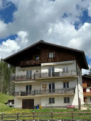 a large building with balconies on the side of it at Mansarda nelle dolomiti in Falcade