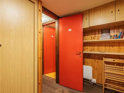 an orange door in a room with wooden walls at Apartment Boiserie by Interhome in Campitello di Fassa