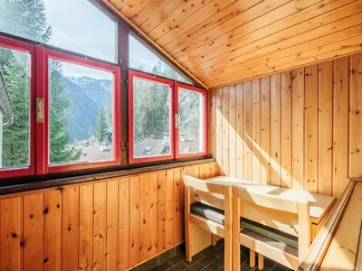 a wooden room with a bench and windows at Apartment Boiserie by Interhome in Campitello di Fassa