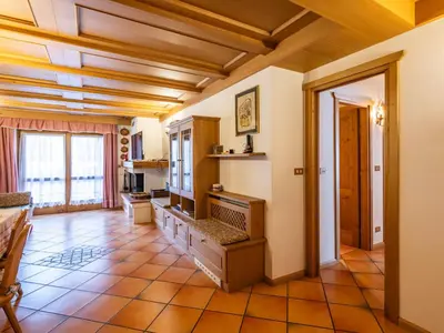 a living room with a television and a tiled floor at Apartment Corte dei Larici by Interhome in Campitello di Fassa