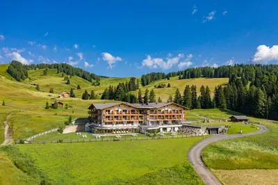 an aerial view of a large building on a hill at Brunelle Seiser Alm Lodge in Alpe di Siusi