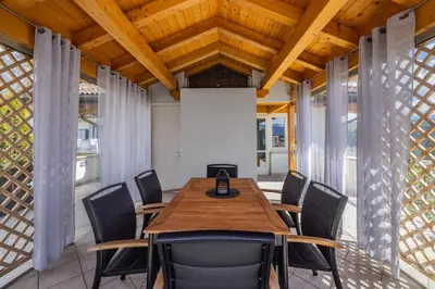 a conference room with a wooden table and chairs at Villa Azzurra, Cloz Ospitar in Cloz